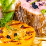 Close up roast pork tenderloin with apricot and Tasmanian pepperberry.