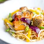 Salmon stir fry with egg noodles and vegetables.