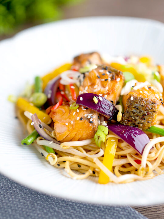 Salmon stir fry with egg noodles and vegetables.