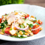 Crunchy & spicy Thai chicken salad with peanuts cucumber & tomatoes.