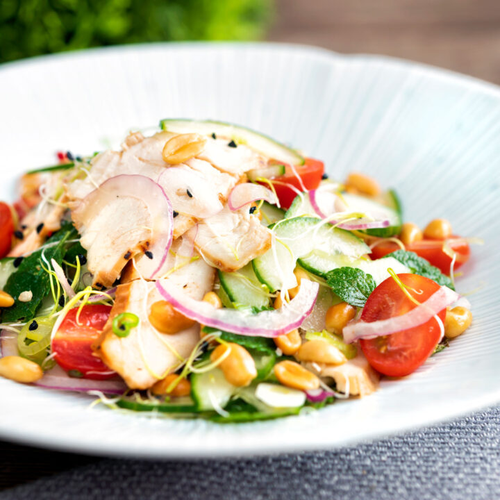 Crunchy & spicy Thai chicken salad with peanuts cucumber & tomatoes.