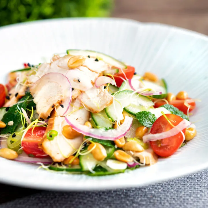 Crunchy & spicy Thai chicken salad with peanuts cucumber & tomatoes.