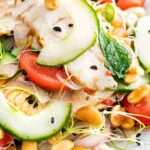 Close up crunchy & spicy Thai chicken salad with peanuts.