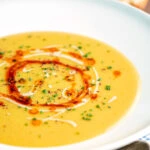 Turkish lentil soup or mercimek corbasi with paprika butter and tahini swirls.