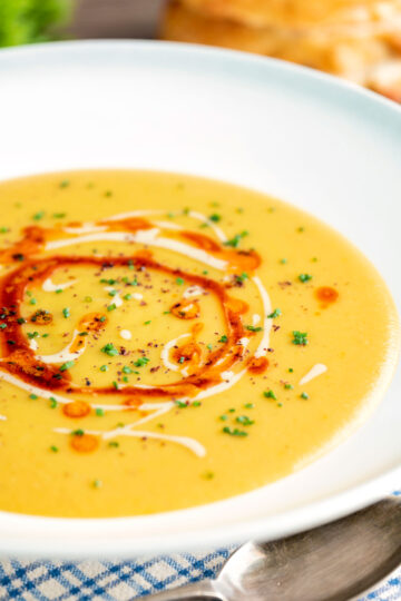 Turkish lentil soup or mercimek corbasi with paprika butter and tahini swirls.