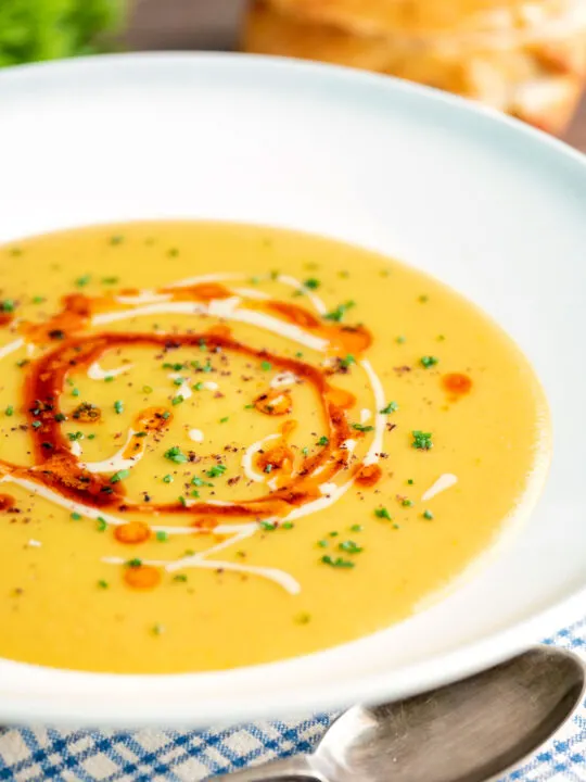 Turkish lentil soup or mercimek corbasi with paprika butter and tahini swirls.