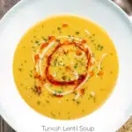 Overhead Turkish lentil soup or mercimek corbasi with paprika butter and tahini swirls featuring a title overlay.