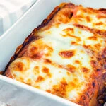 Goats cheese cannelloni with spinach served in a baking dish.