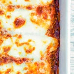 Overhead Goats cheese cannelloni with spinach served in a baking dish.