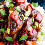Close up honey chilli chicken made with chicken tenders, red peppers and spring onions.
