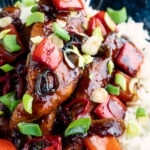 Close up honey chilli chicken made with chicken tenders, red peppers and spring onions.