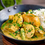 Keralan fish curry with coconut milk featuring green beans and potato in a karai.