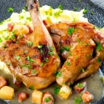 Close up pheasant casserole with a cider gravy, bacon & apples served with mashed potatoes.