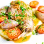 Rabbit Cacciatore or Coniglio alla Cacciatora with shallot and cherry tomatoes on polenta featuring a title overlay.