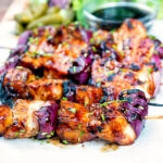 BBQ chicken skewers with pineapple and red onion with a sweet and sour glaze.