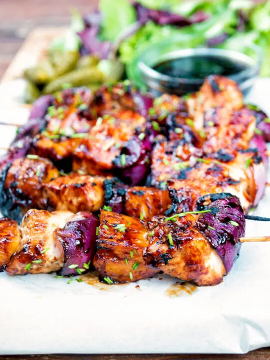 BBQ chicken skewers with pineapple and red onion with a sweet and sour glaze.