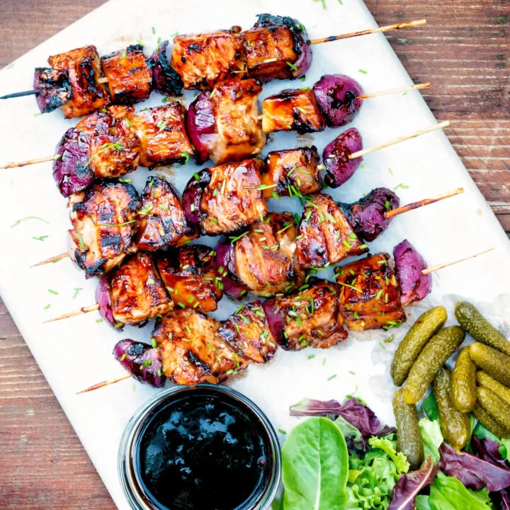 Overhead BBQ chicken skewers with pineapple & red onion with a sweet & sour glaze.