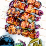 Overhead BBQ chicken skewers with pineapple & red onion with a sweet and sour glaze.