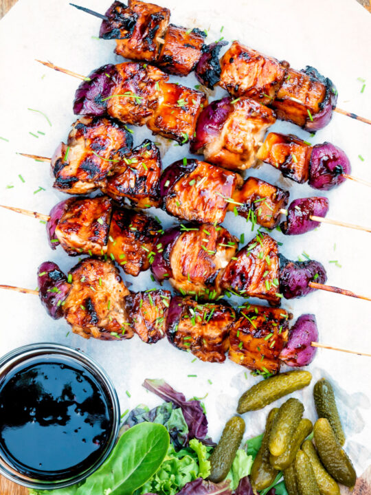 Overhead BBQ chicken skewers with pineapple & red onion with a sweet and sour glaze.