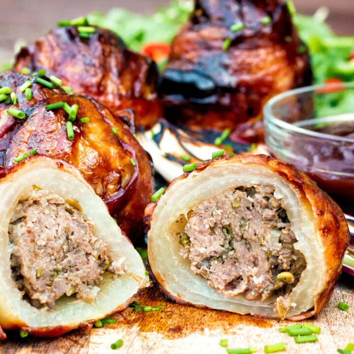 Stuffed onions wrapped in bacon & BBQ sauce glaze showing minced beef stuffing.