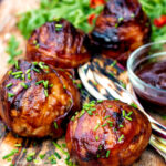 Stuffed onions wrapped in bacon & BBQ sauce glaze featuring a title overlay.