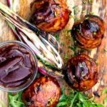 Overhead stuffed onions wrapped in bacon & BBQ sauce glaze.