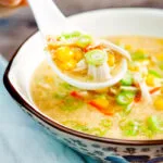 Chinese style chicken and sweetcorn soup on a spoon.