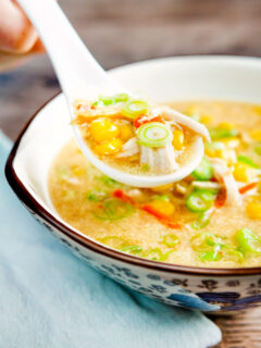 Chinese style chicken and sweetcorn soup on a spoon.