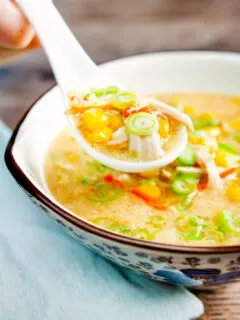 Chinese style chicken and sweetcorn soup on a spoon.