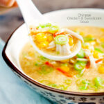 Chinese style chicken and sweetcorn soup on a spoon featuring a title overlay.