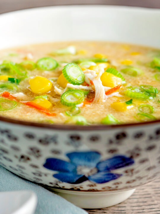 Chinese style chicken and sweetcorn soup served in a flower decorated bowl.