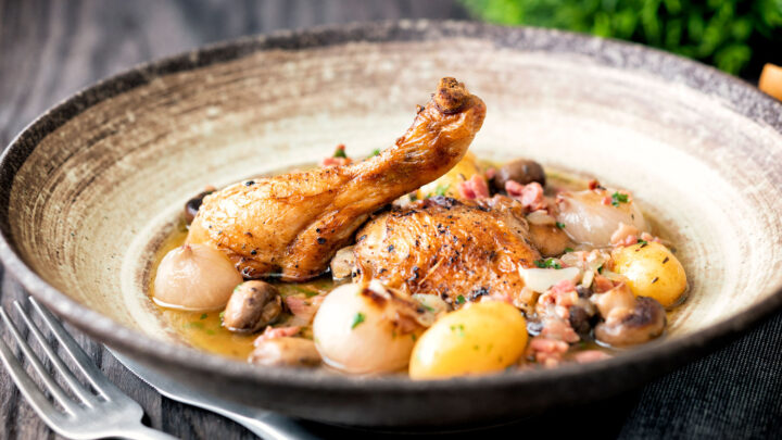 Coq au vin blanc with baby potatoes bacon and baby potatoes.