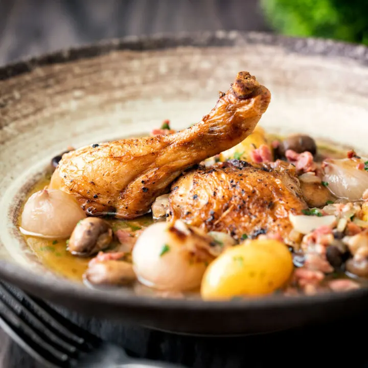 Coq au vin blanc with baby potatoes bacon and baby potatoes.