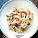 Overhead creamy chicken and bacon pasta served in a white bowl featuring a title overlay.