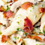 Close up creamy chicken and bacon pasta featuring a title overlay.