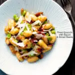 Overhead pan fried gnocchi with bacon, broad beans and parmesan shavings featuring a title overlay.
