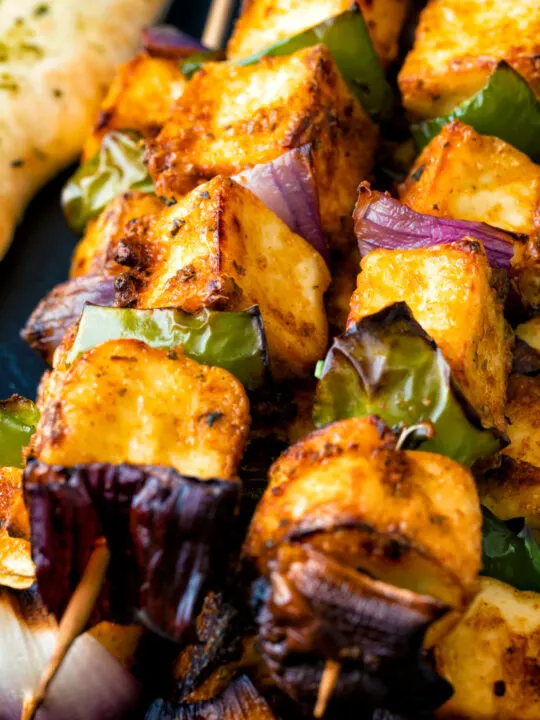 Close up paneer tikka skewers.