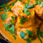 Close up paneer tikka masala curry served in an iron karai with naan bread featuring a title overlay.