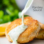White parsley sauce poured from a jug over a fishcake featuring a title overlay.