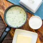 White parsley sauce in a milk pan with butter and flour.