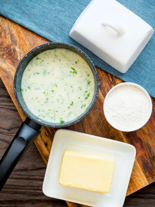 White parsley sauce in a milk pan with butter and flour.