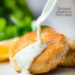 Smoked haddock fishcakes with parsley sauce being poured over them featuring a title overlay.