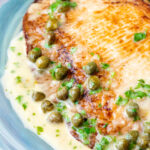 Close up pan fried skate wings served with a prosecco and caper butter sauce.