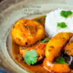 Close up aloo paneer or chanar dalna served in a bowl with rice and coriander featuring a title overlay.