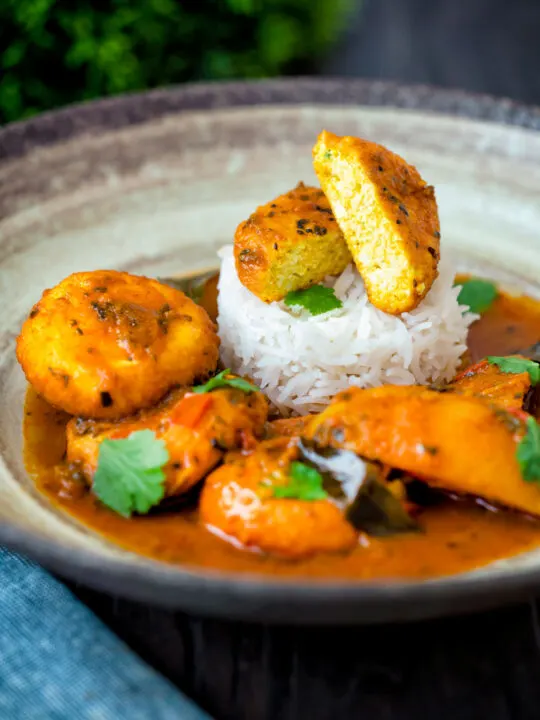 Aloo paneer curry or chanar dalna showing cut open paneer ball.