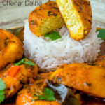 Close up aloo paneer curry or chanar dalna showing cut open paneer ball featuring a title overlay.