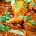 Close up chicken rogan josh curry with fresh coriander featuring a title overlay.