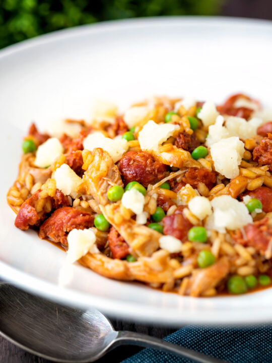 Chicken and chorizo risotto with green peas and Manchego cheese.