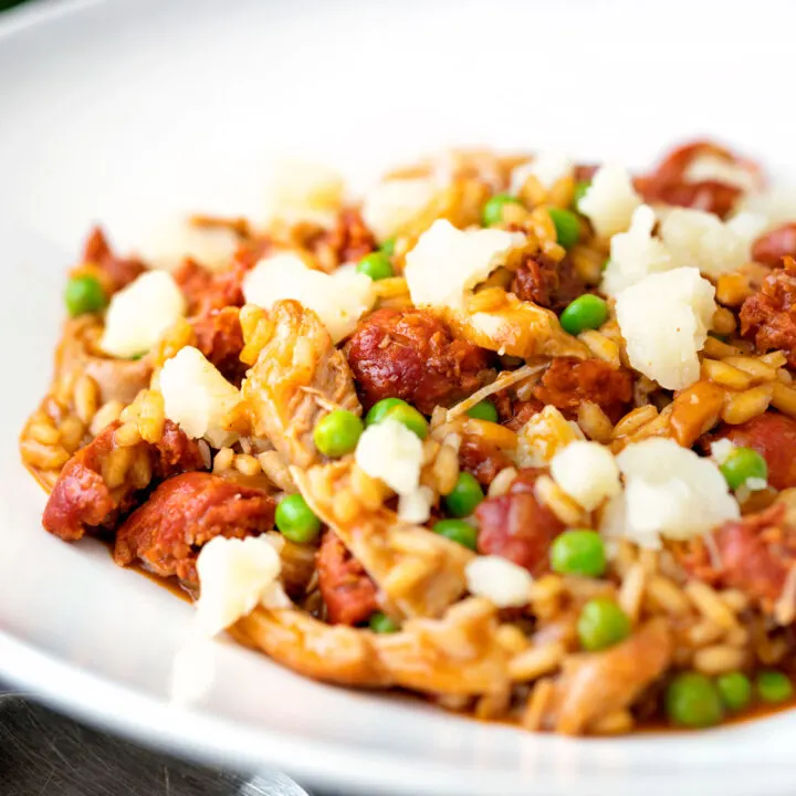 Chicken and chorizo risotto with green peas and Manchego cheese.