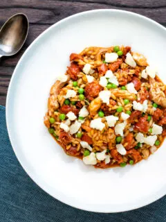 Overhead chicken and chorizo risotto with green peas and Manchego cheese.